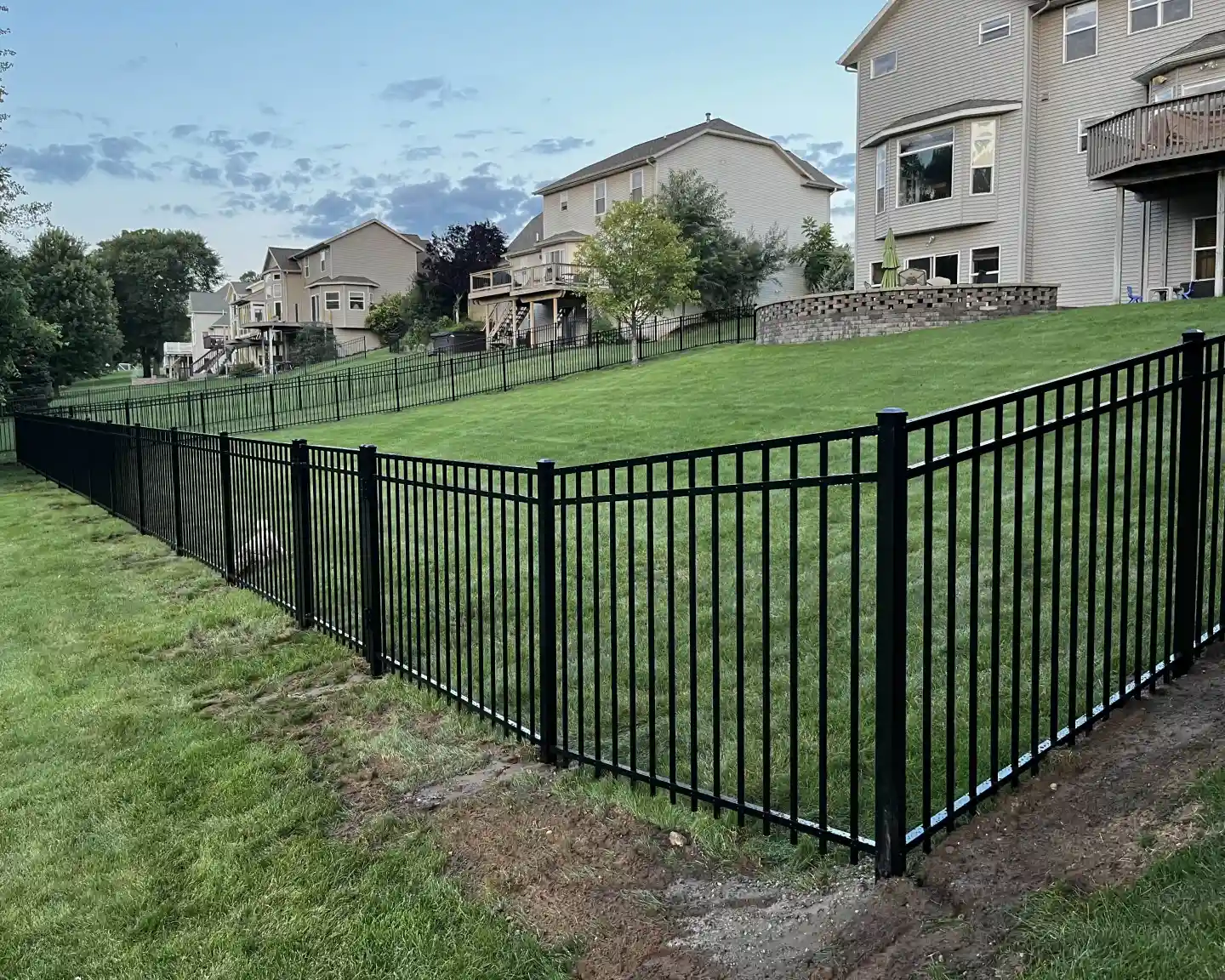 aluminum fence installation in residential backyard