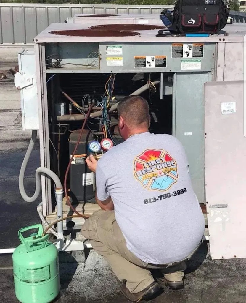 HVAC technician performing a tune-up on an air conditioning unit, highlighting expert maintenance services