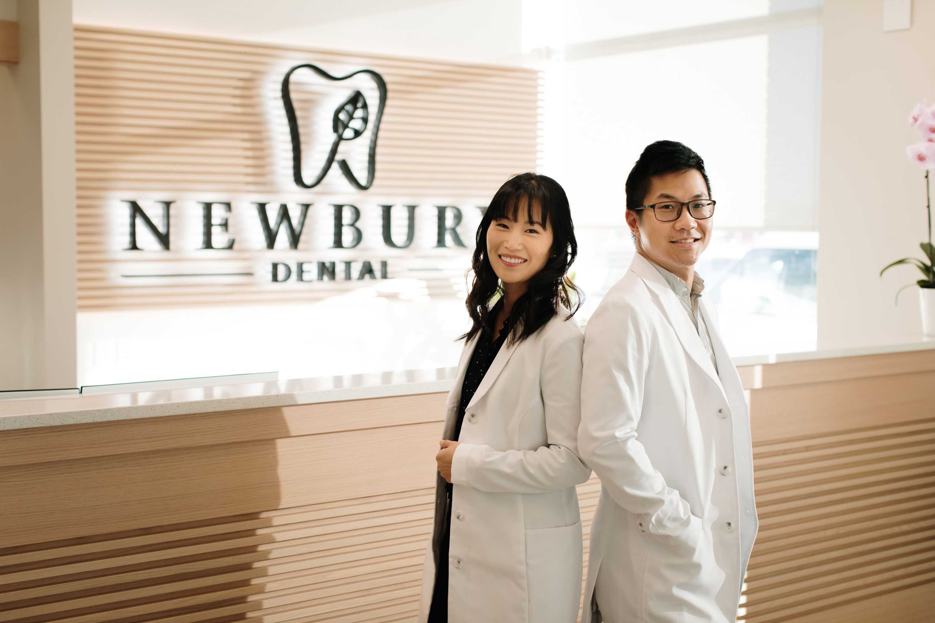 Dr. Linda Lee and Dr. Marcus Ngai standing in the waiting area of Newbury Dental in Edmonton, Alberta, Canada