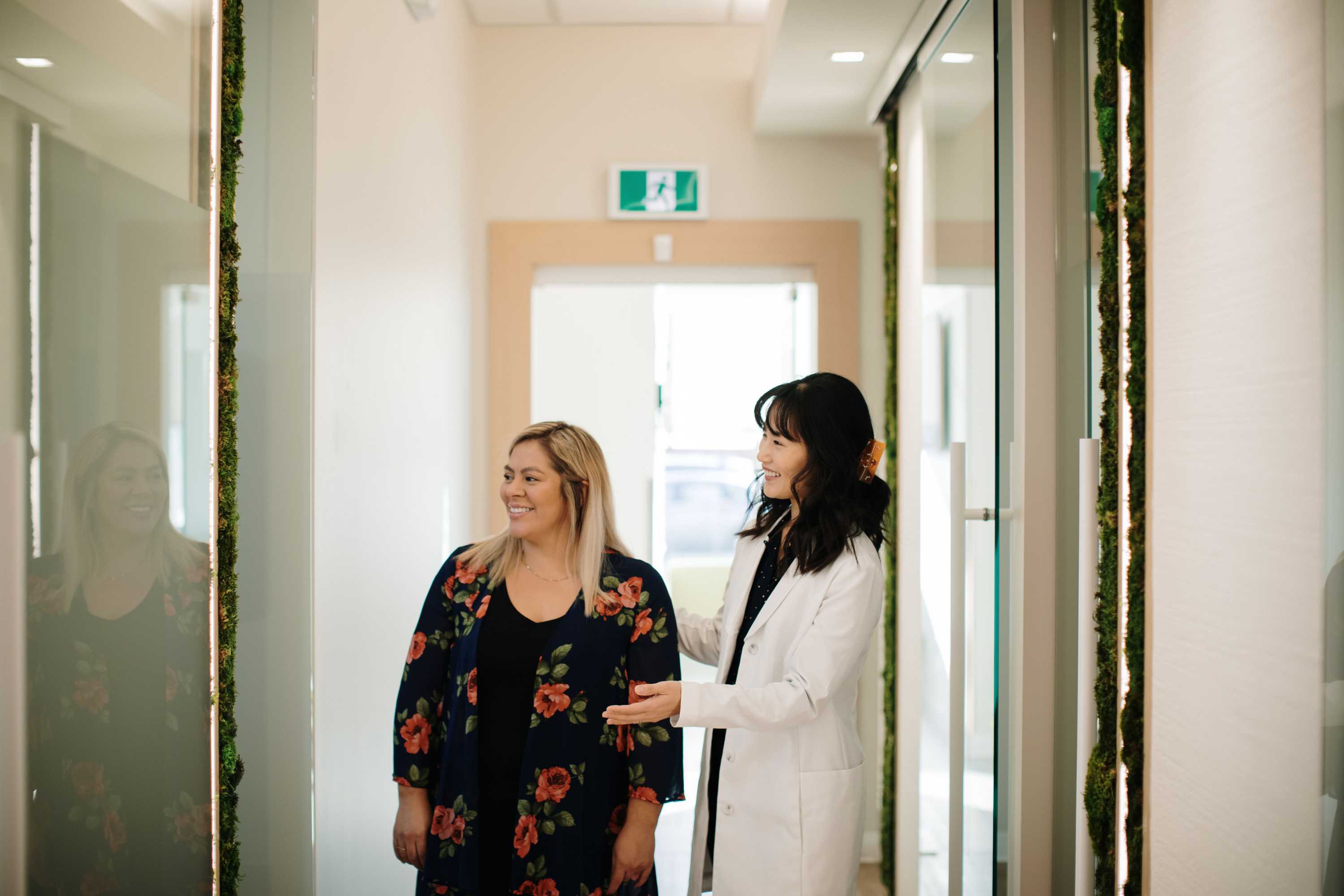 Dr. Linda Lee walking down the hall with a patient