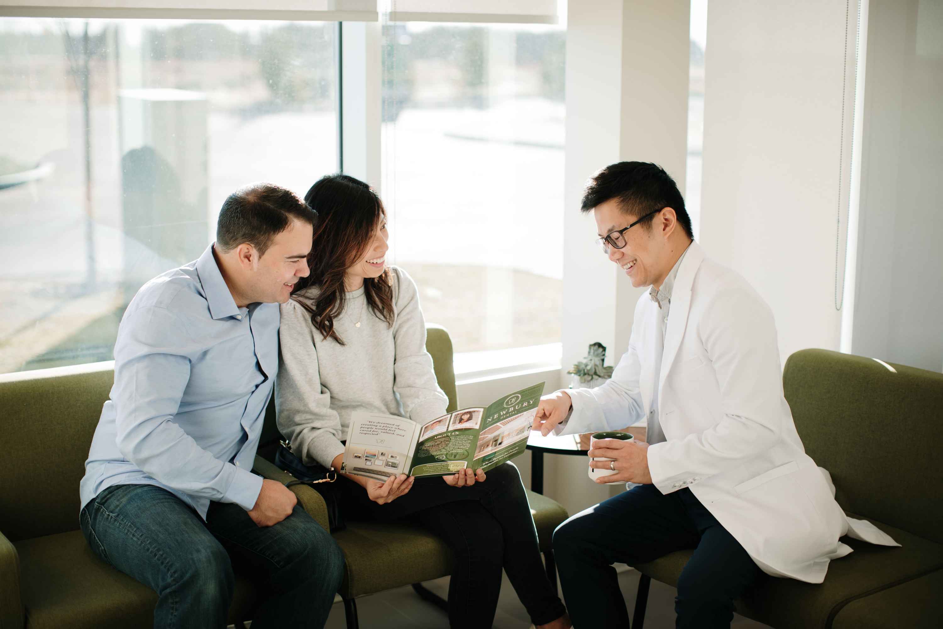 Dr. Ngai discussing insurance options with a couple