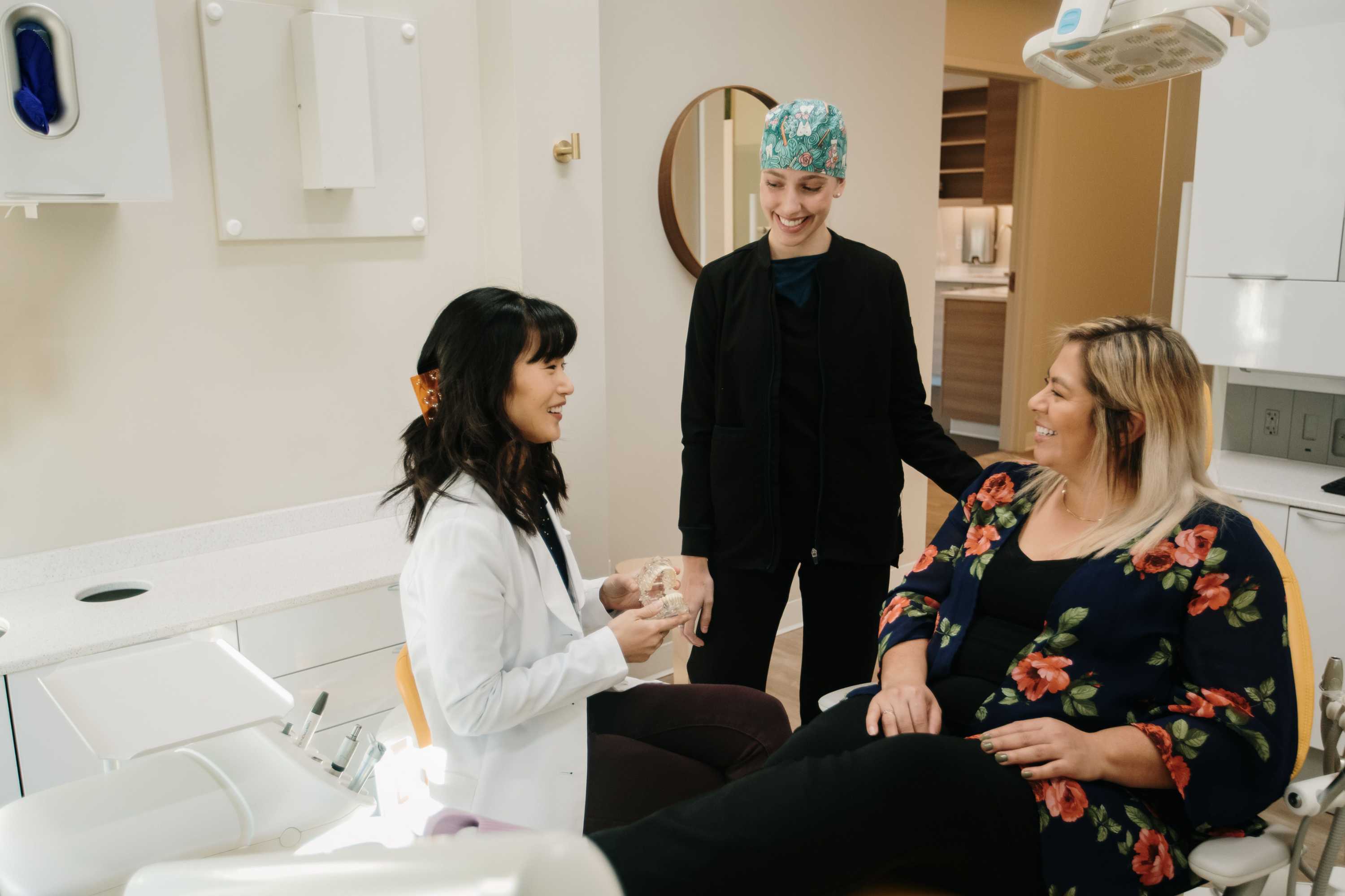 Dr. Linda Lee and hygienist discussing invisalign with a patient