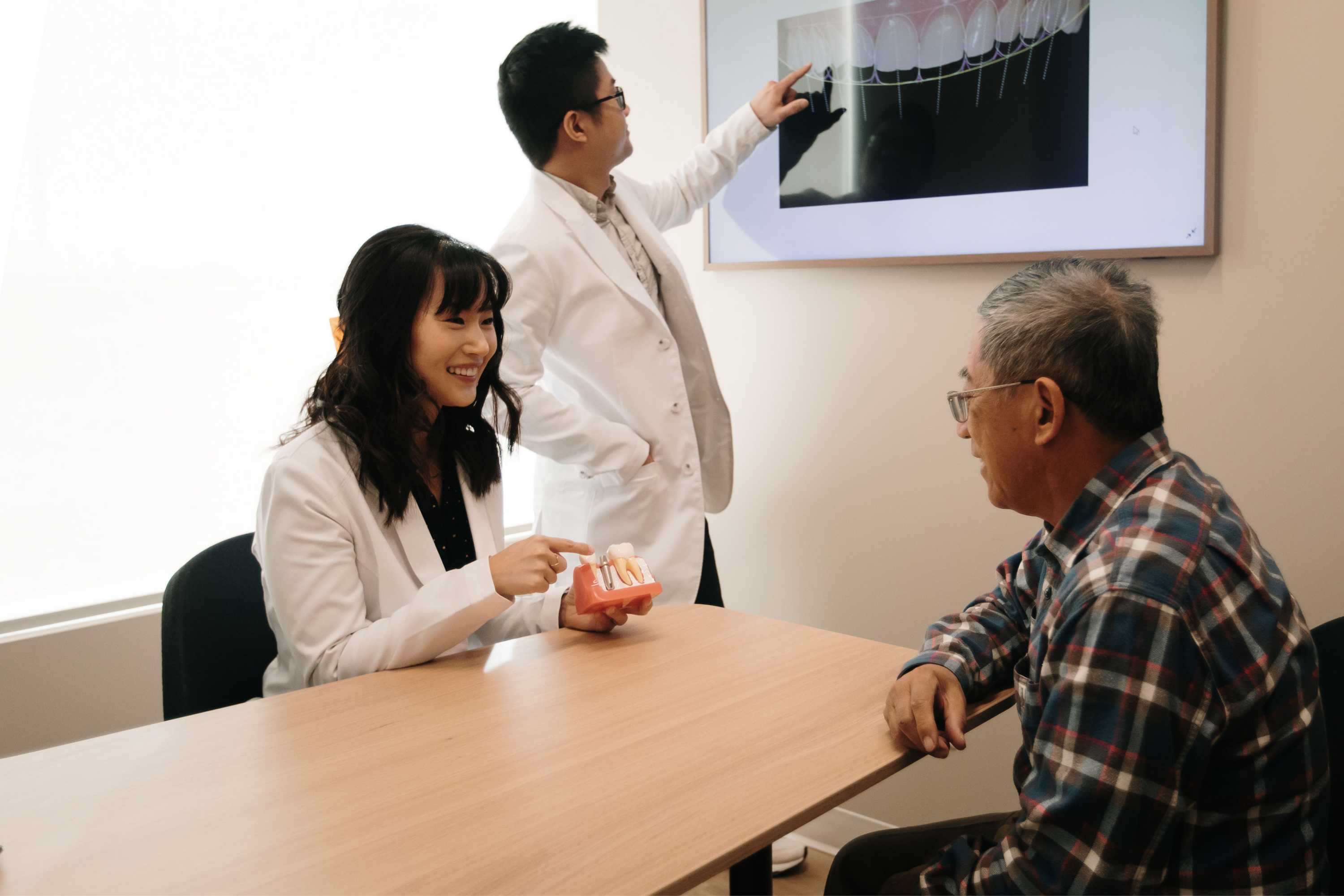 Dr. Linda Lee and hygienist discussing invisalign with a patient