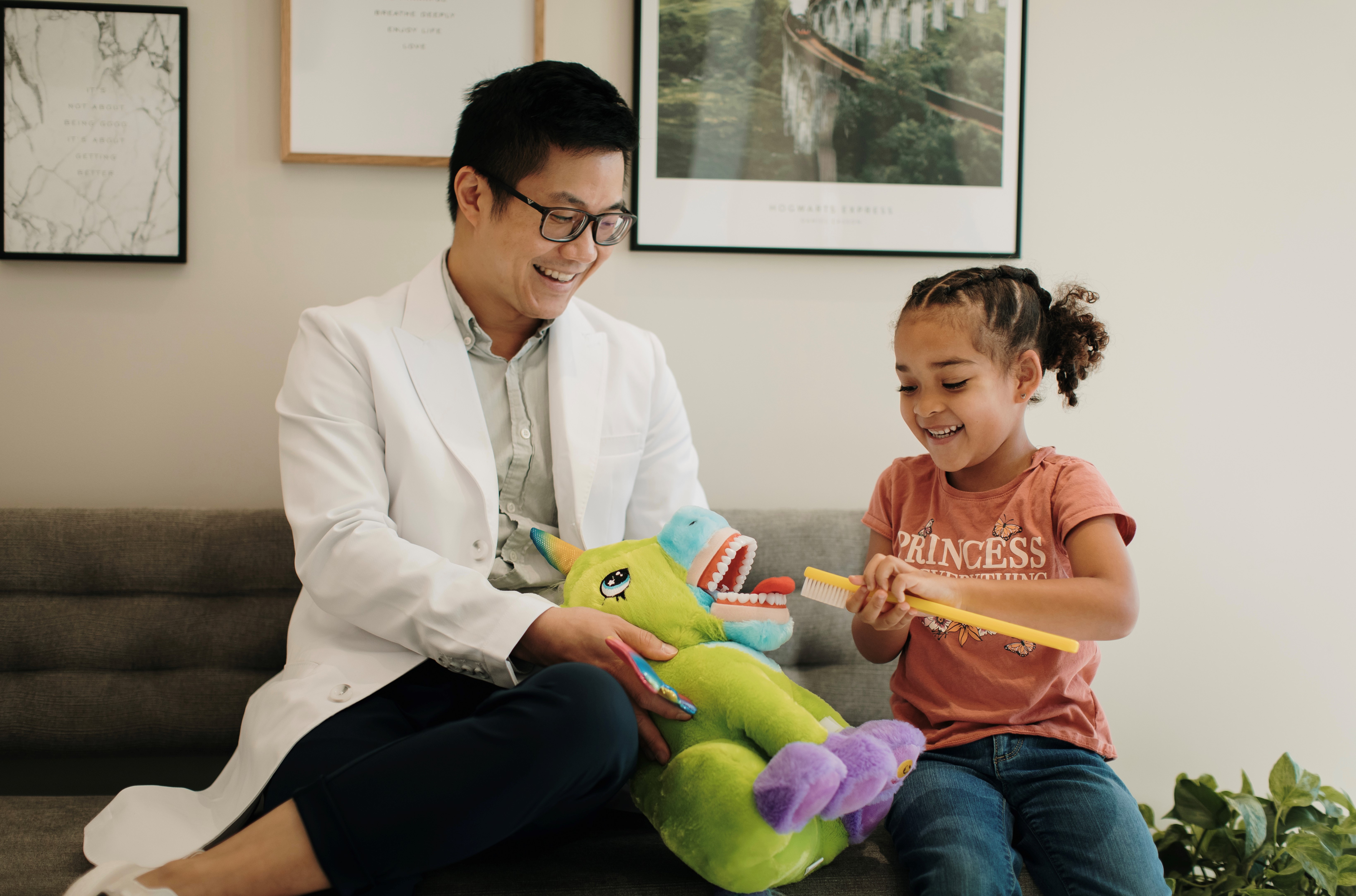 Dr. Ngai educating a child regarding oral health