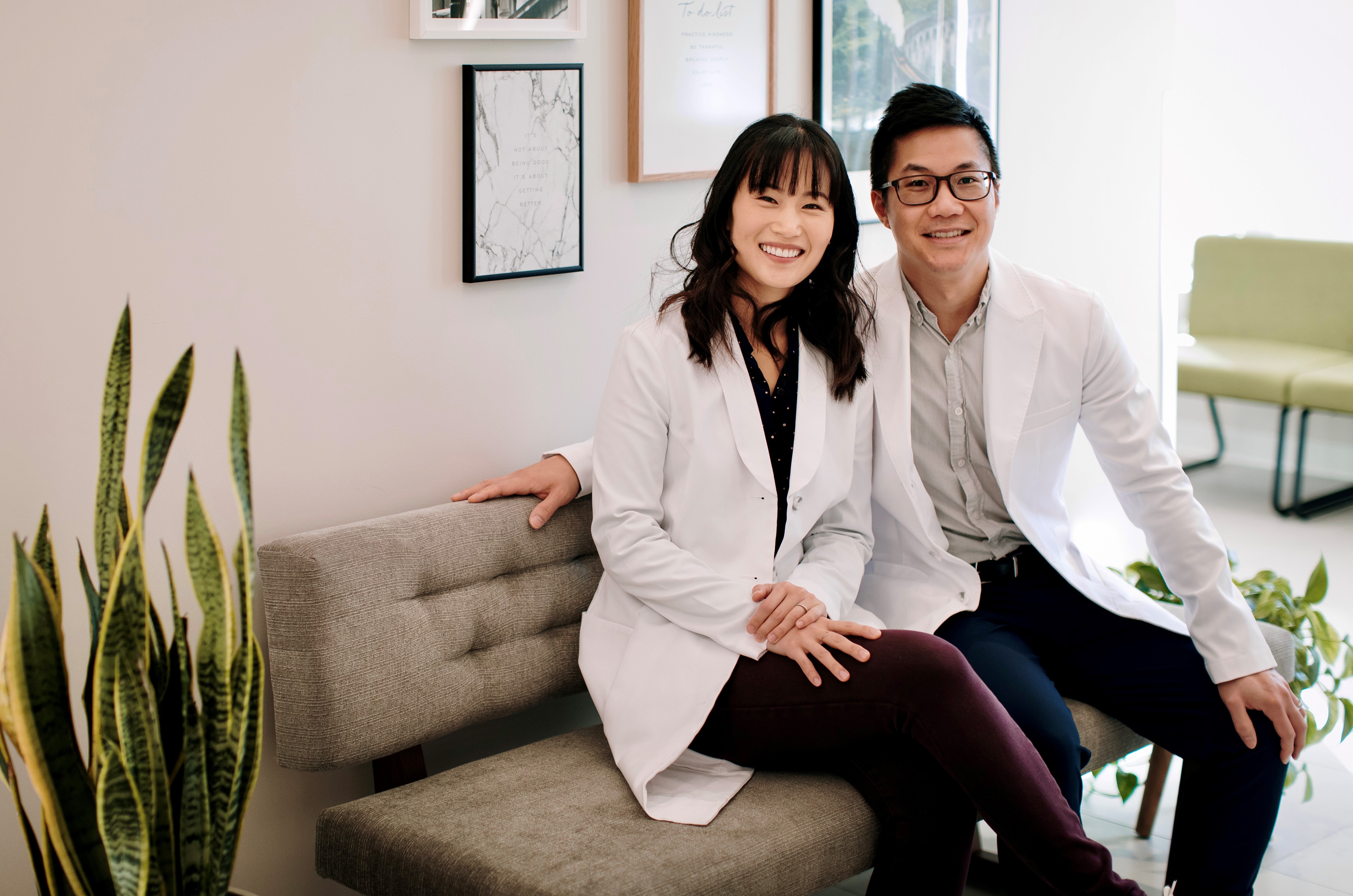 Dr. Lee locking arms with Dr. Ngai in the waiting room of Newbury Dental