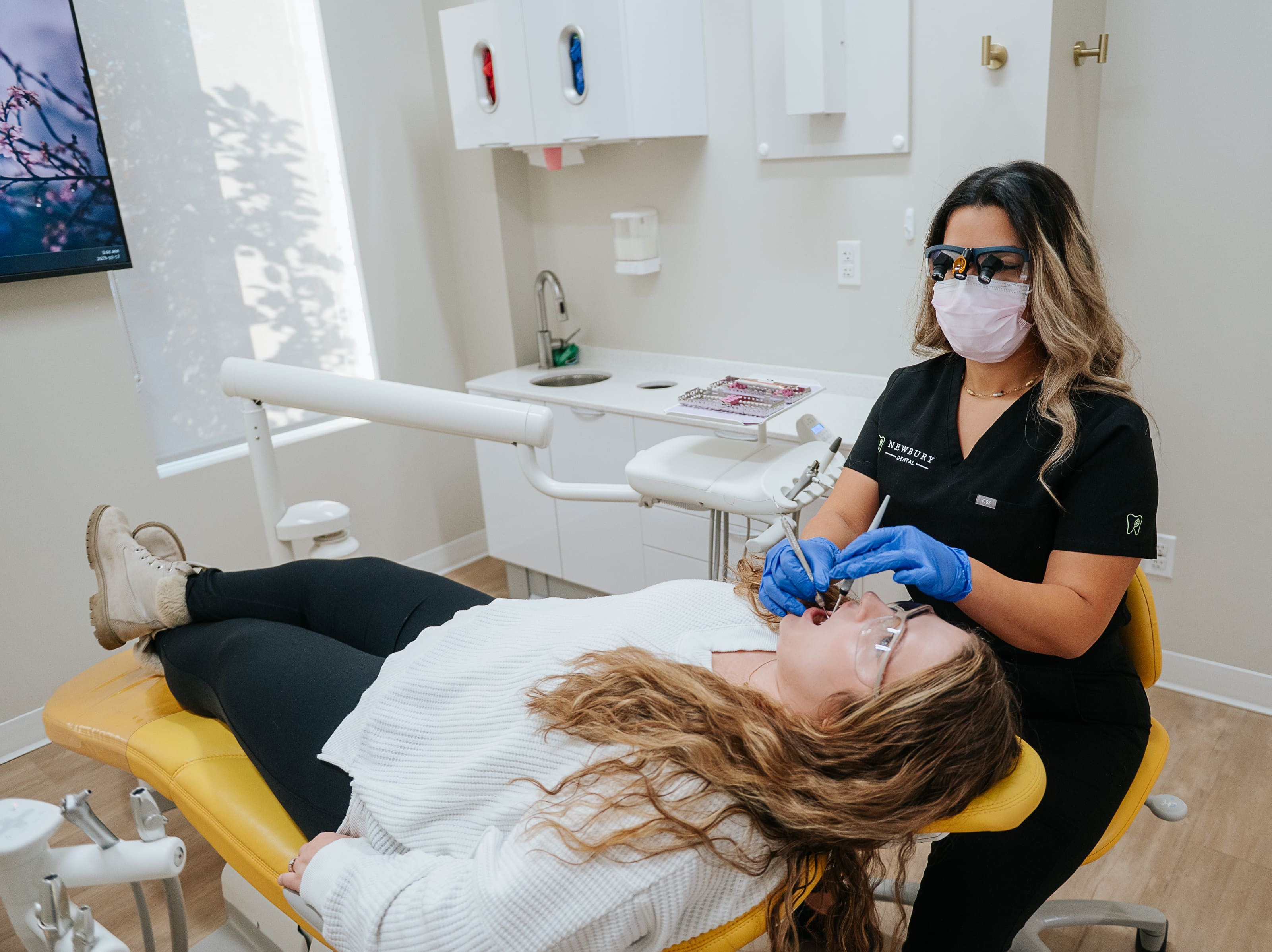 Dr. Lee, Dr. Ngai, and hygienist prepping a patient for procedure