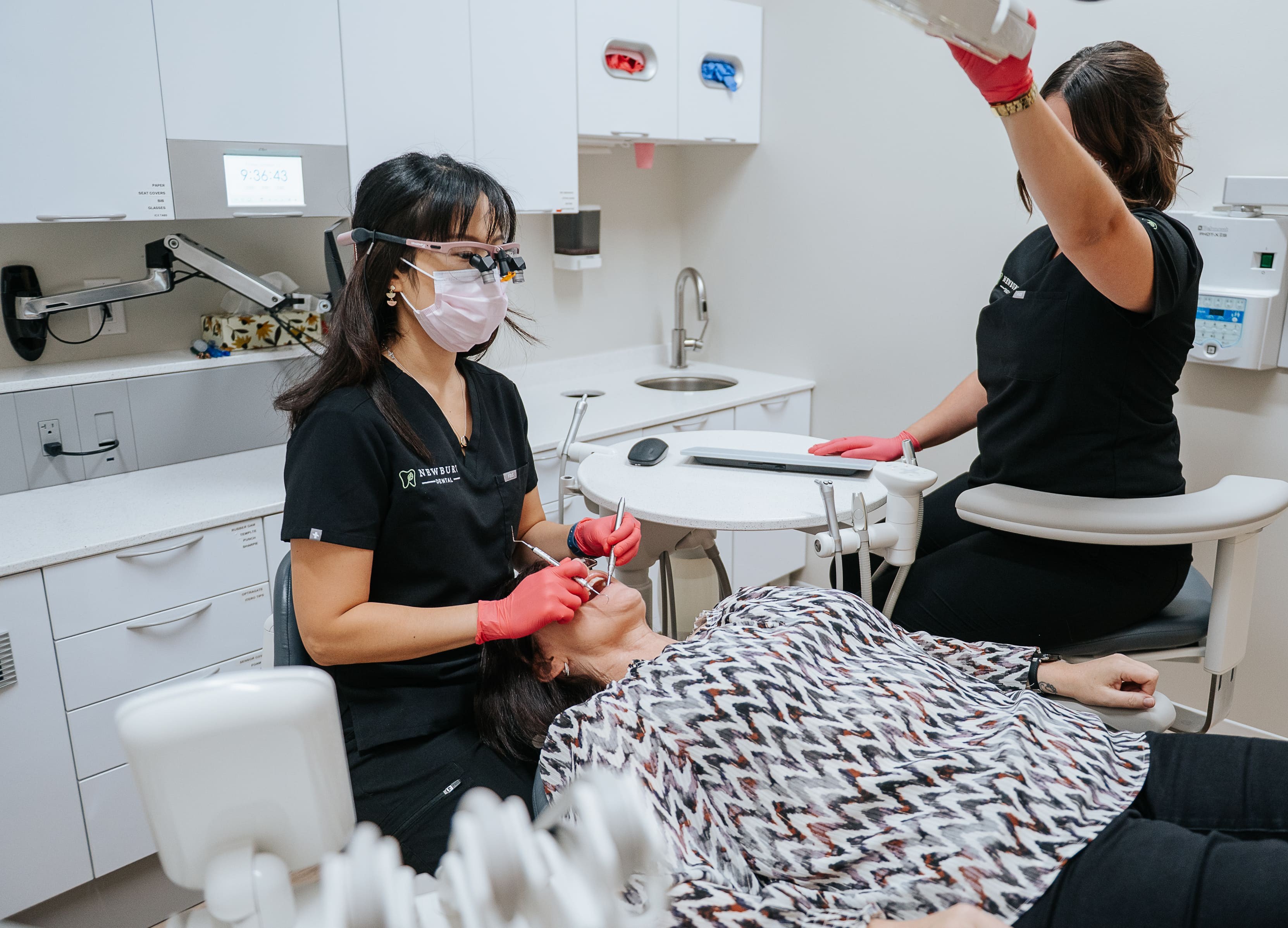 Dr. Linda Lee and hygienist discussing invisalign with a patient
