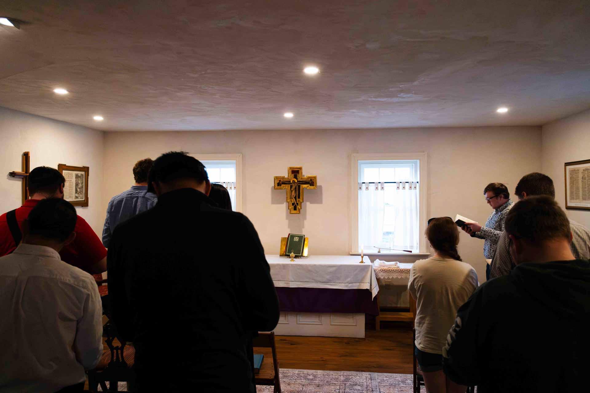 Participants standing in prayer during an ecumenical chapel service