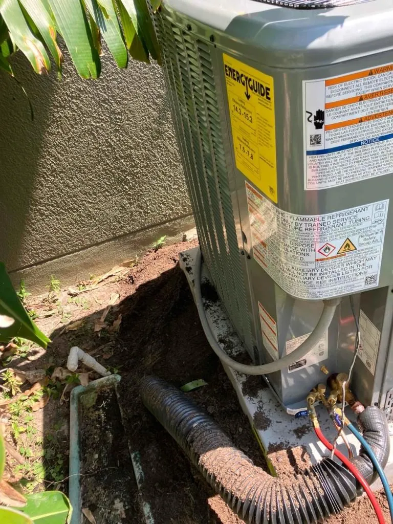 Air conditioning unit with yellow energy guide label next to a wall
