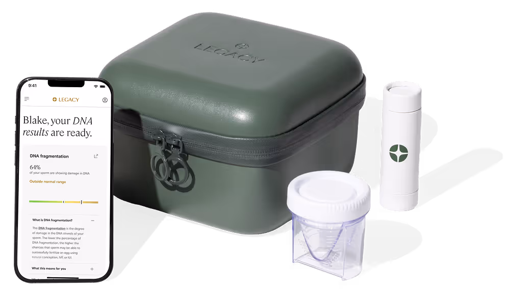 A DNA testing kit including a green Legacy-branded case, a white collection container, a cylindrical tube with a green logo, and a smartphone showing DNA results.