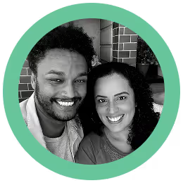 Smiling man and woman with curly hair in a black and white circular portrait with a green border.
