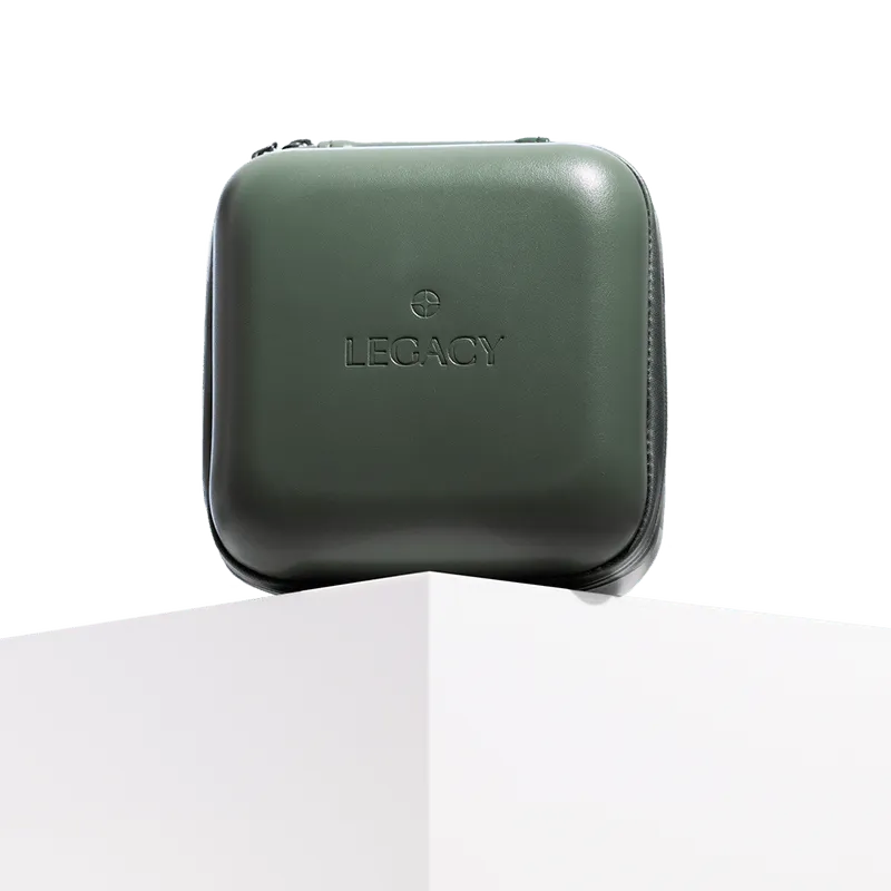 Closed dark green Legacy-branded square hard case with rounded corners on a white pedestal.