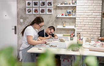 Two students working with clay during an art class