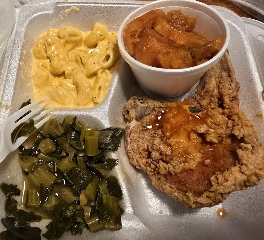 Fried chicken with mac n' cheese, sweet potato, and collard greens