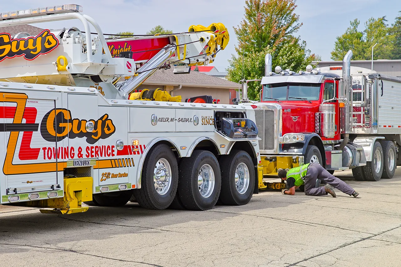 Roadside breakdown towing recovers a semi truck with a heavy-duty wrecker on US-151.