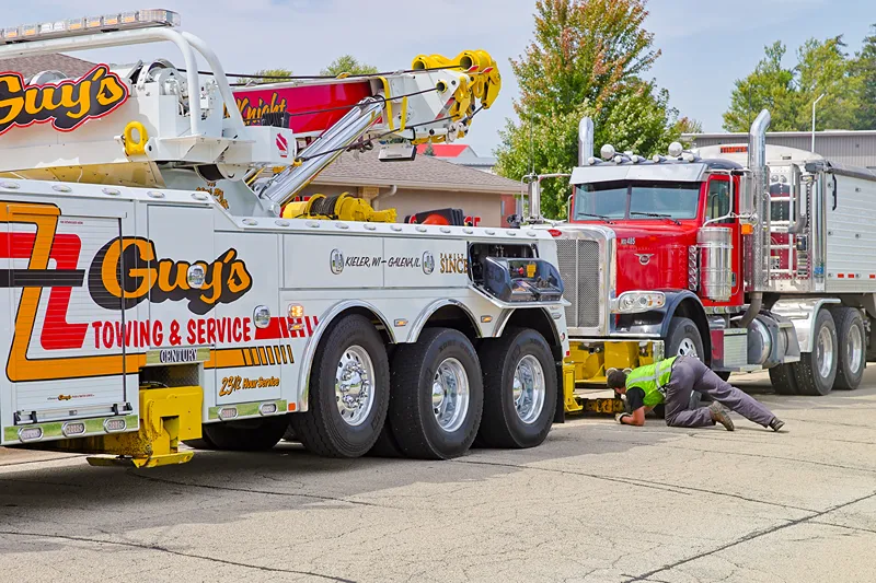 Roadside breakdown towing recovers a semi truck with a heavy-duty wrecker on US-151.
