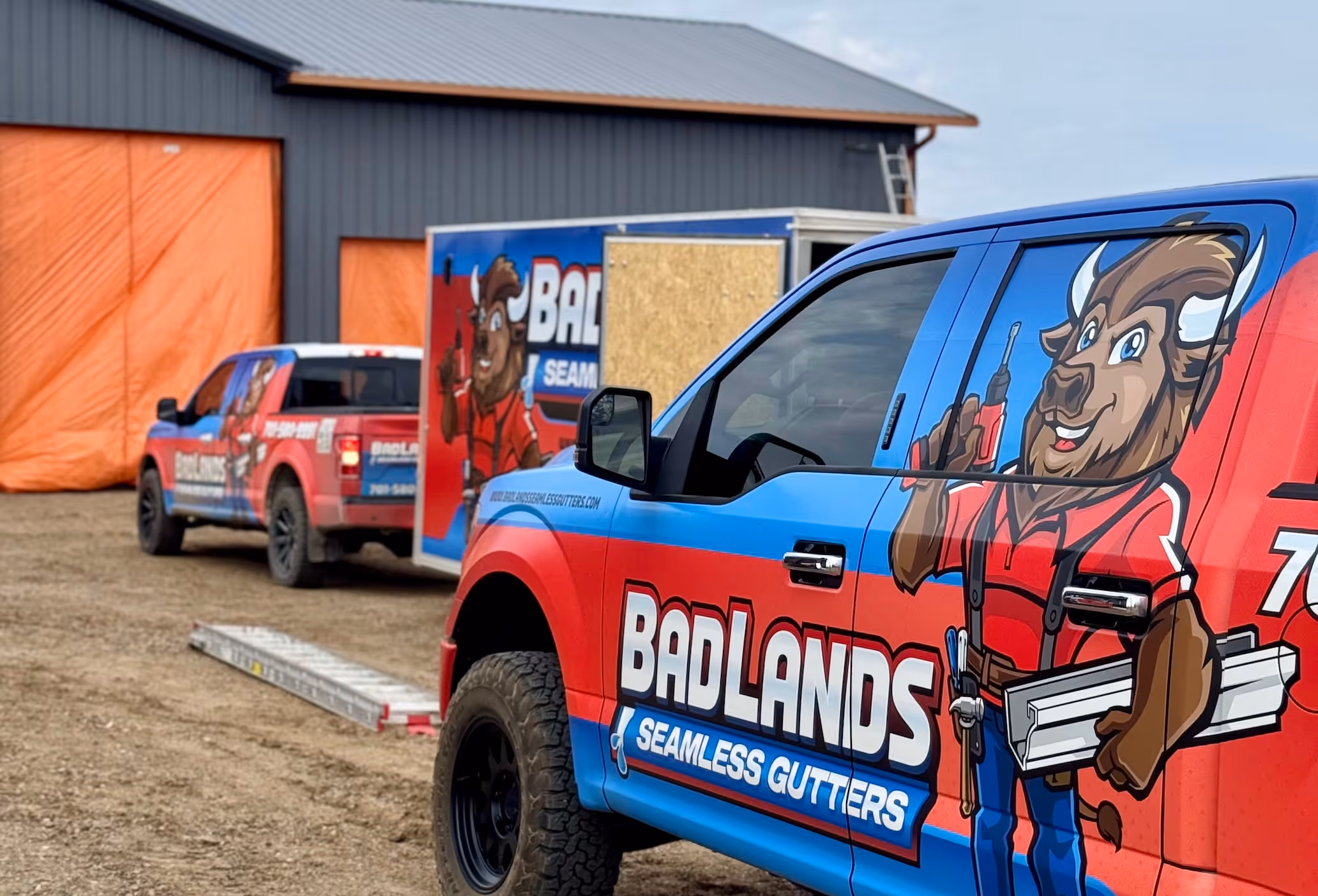 Badlands Seamless Gutter trucks with vivid custom vinyl wraps, portraying the Badlands Bison