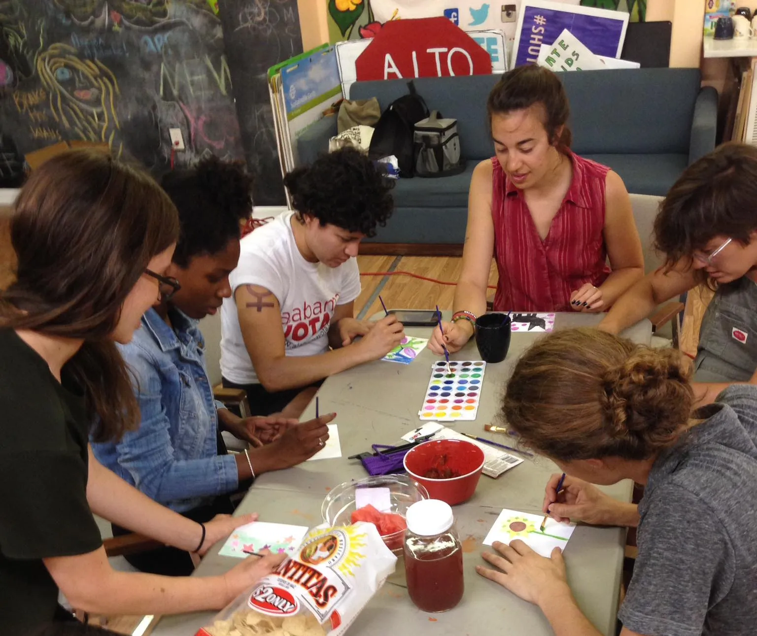 Group of organizers working around table on letters to prisoners.