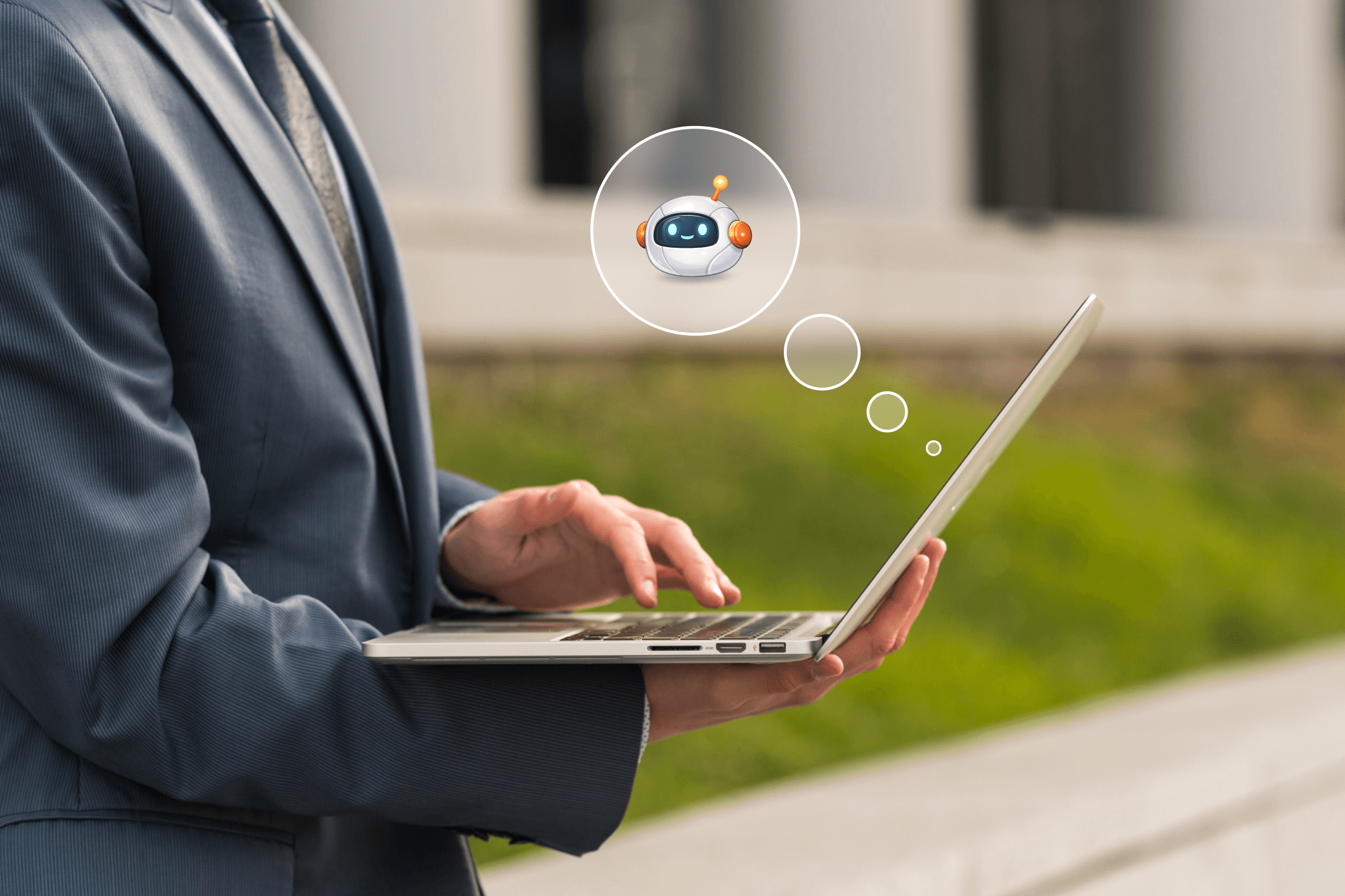 Business professional using a laptop with an AI chatbot icon floating above it.