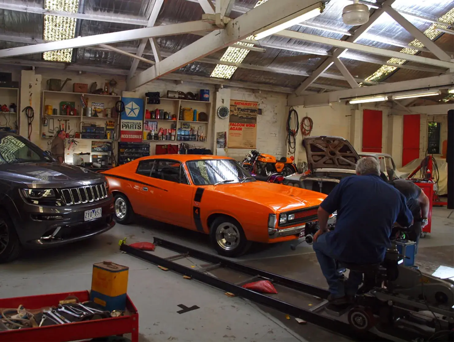 Orange Chrysler Charger in a garage workshop during filming of Shannons Insurance for Motoring Enthusiasts campaign.