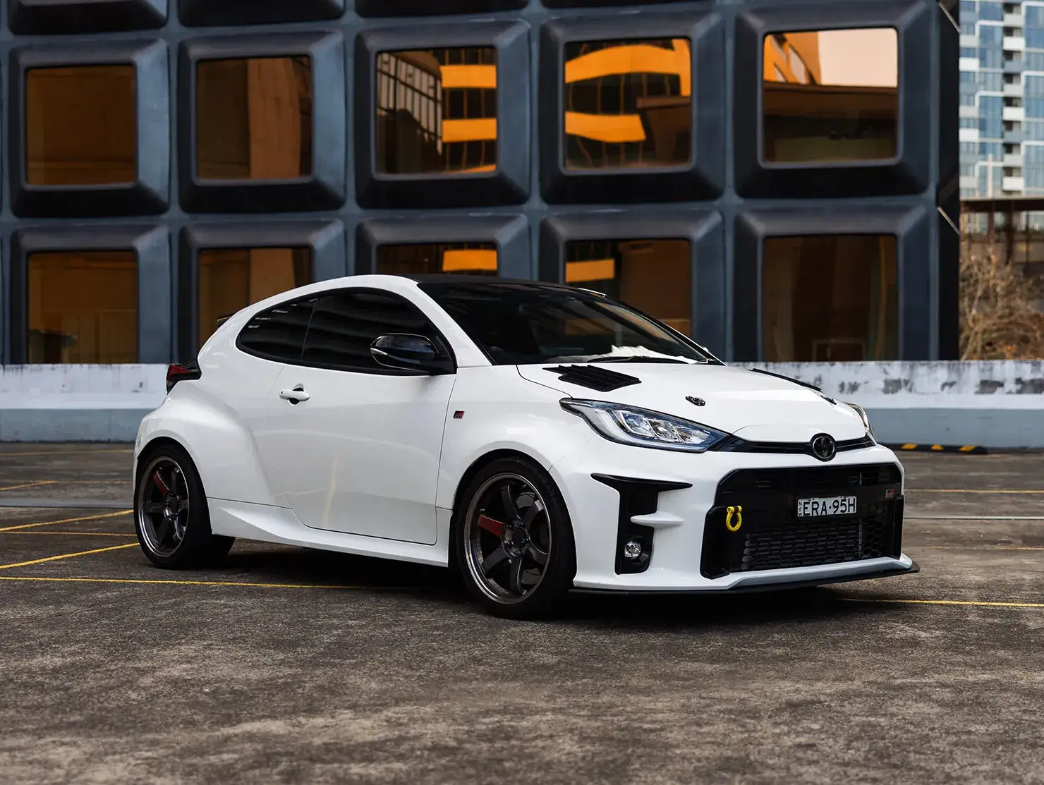 White Toyota GR Yaris hot hatch with black wheels and rally styling, parked in city location - Shannons Vehicle Photography