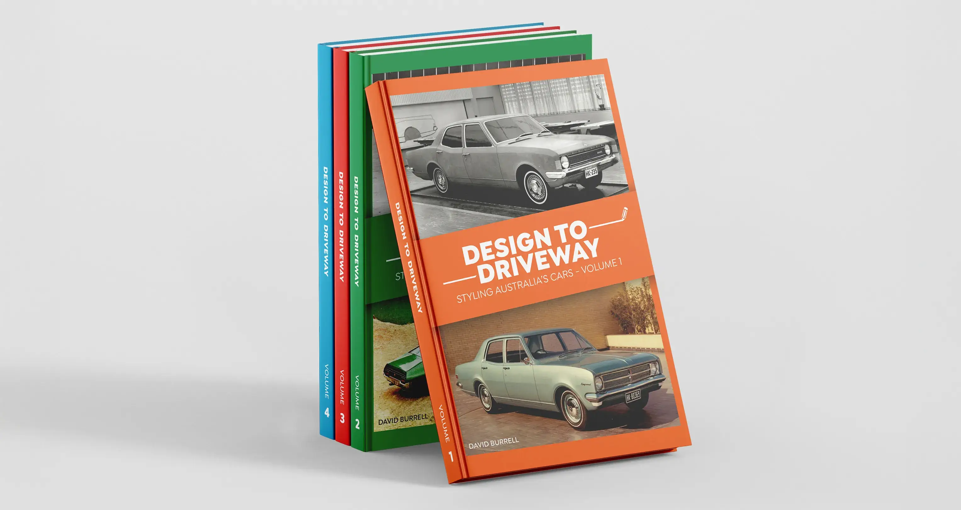 A stack of the Design to Driveway book series featuring colourful covers with Australian classic cars, showcasing volumes 1–4 in the collection.