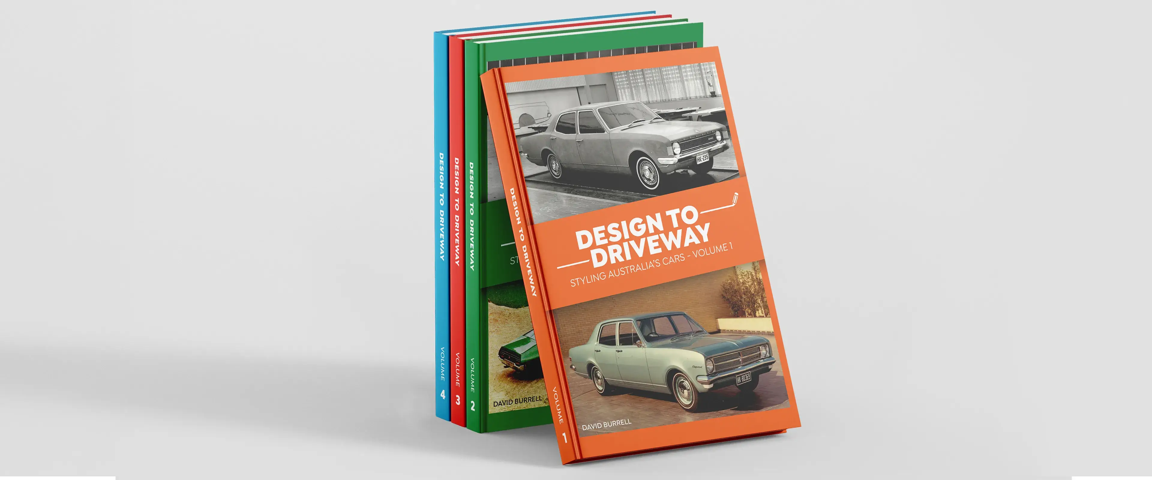 A stack of the Design to Driveway book series featuring colourful covers with Australian classic cars, showcasing volumes 1–4 in the collection.