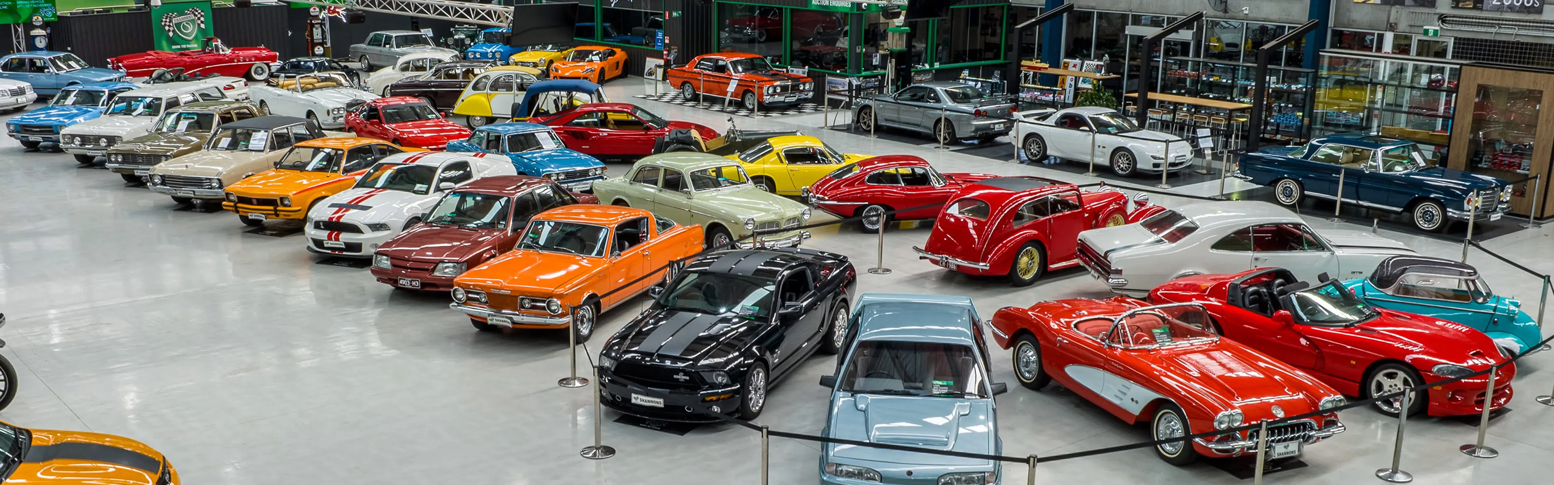 Shannons auction showroom filled with classic and collectible cars, showcasing the variety promoted as part of Shannons Auctions marketing.