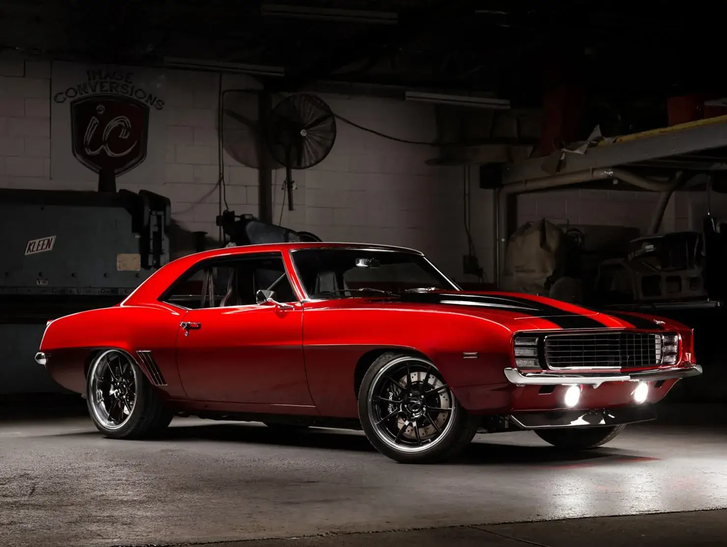 Red Chevrolet Camaro in a workshop setting, showcased in the Shannons Club Online Show and Shine Competition.