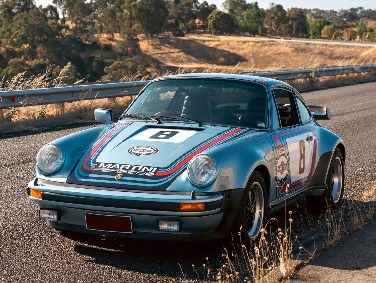 Martini-liveried Porsche 911 on a winding road, entered in the Shannons Club Online Show and Shine Competition.