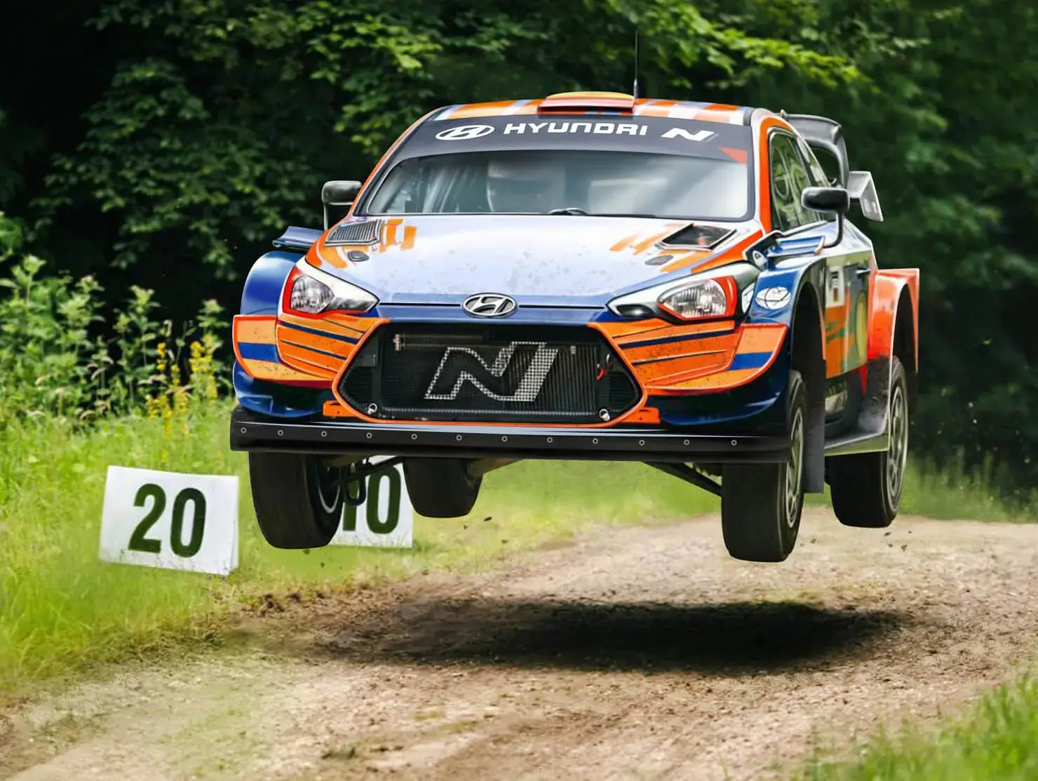 Hyundai rally car airborne on a dirt stage at the Goodwood Festival of Speed, part of Shannons prize trip.