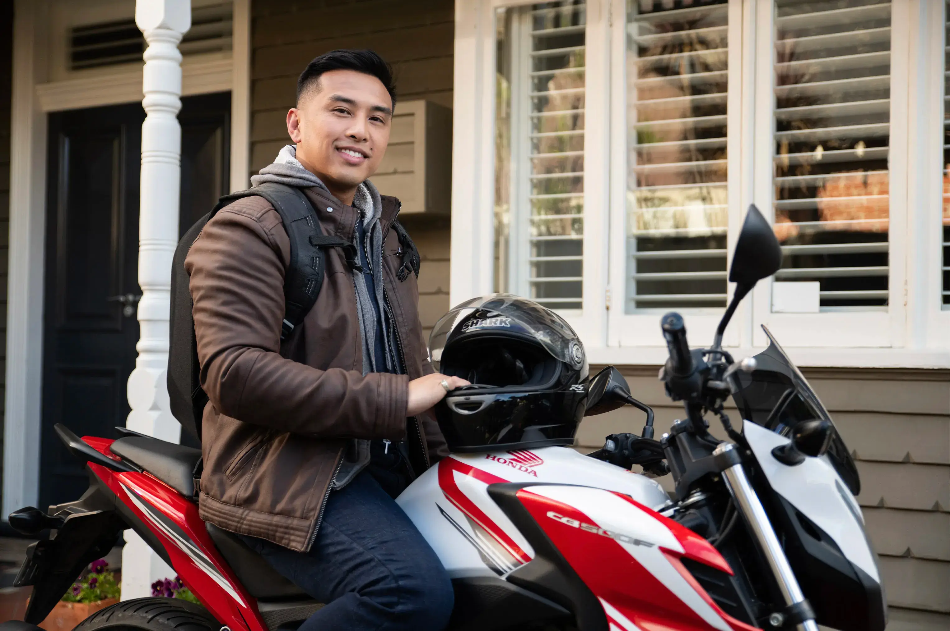 A commuter sitting proudly on his Honda CB500F outside his home, part of the Shannons Bike Insurance campaign.