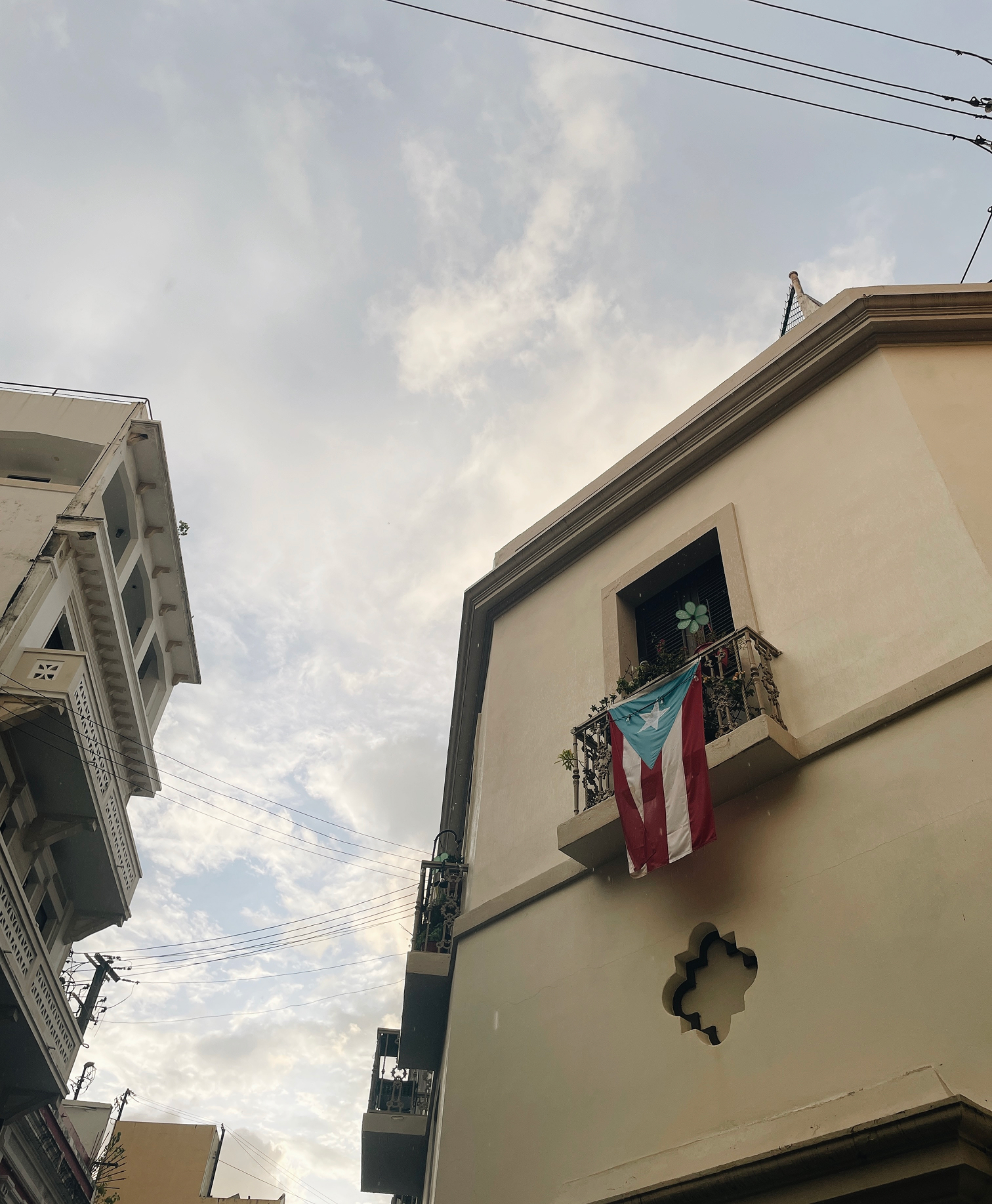 A building with a Puerto Rican flag hanging from a window.