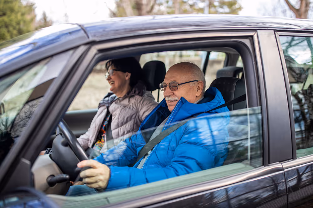 Older adult driving with a passenger