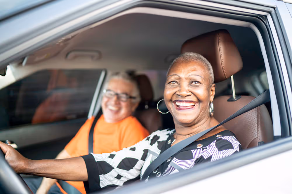 Older adult confidently driving with hands on steering wheel, representing safe and independent driving