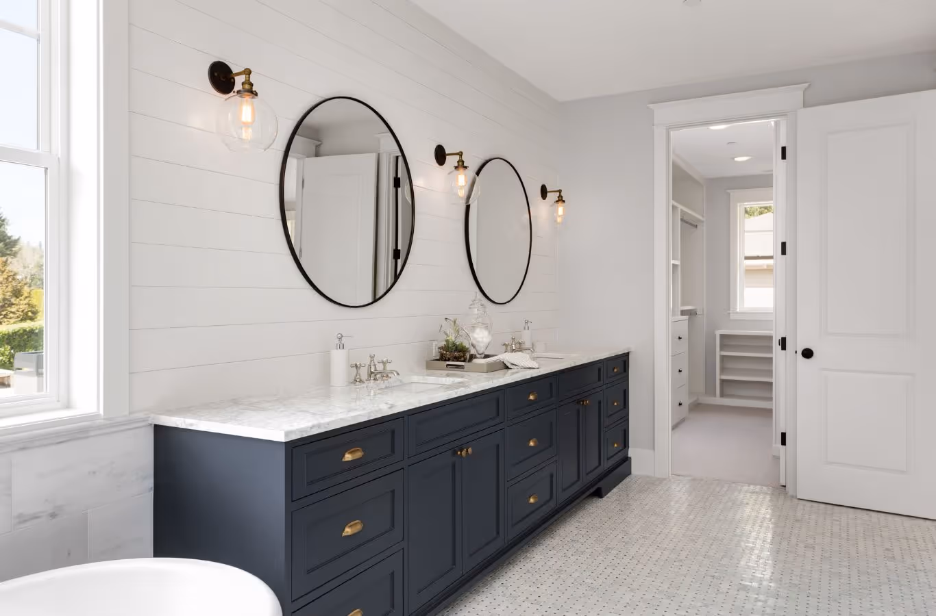 A PMB Property Improvements team member installing new bathroom fixtures and finishes in a St. Pete Beach, FL home.