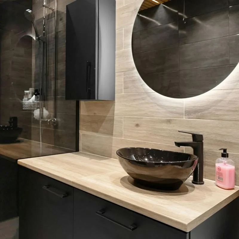 Image of a dark brown / black vanity in a newly remodeled bathroom