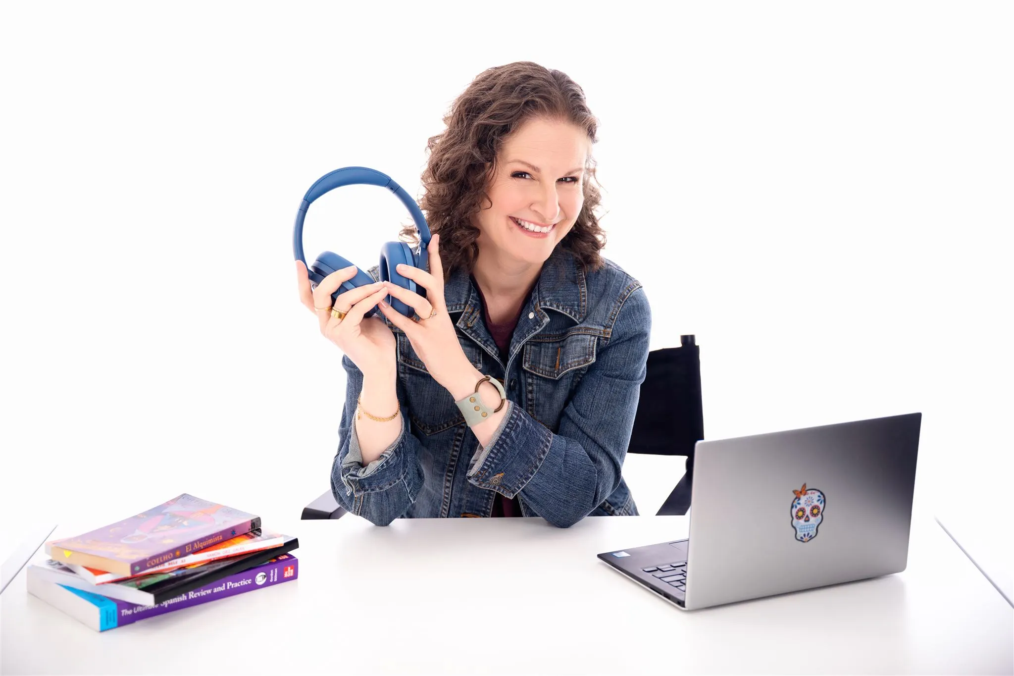 Chief Spanish Officer at Gringo Language Academy teaching an online Spanish class with a laptop, books, and blue headphones.