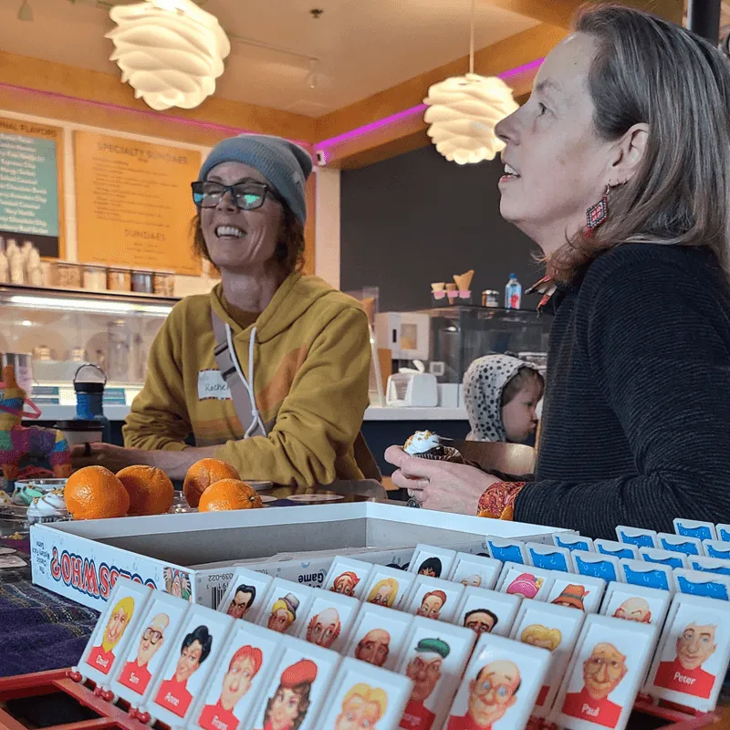 Women playing Spanish language games at the Lingo Latte Lounge MeetUp in Bend, Oregon—an in-person event hosted by Gringo Language Academy at The Grove Market Hall in Northwest Crossing.