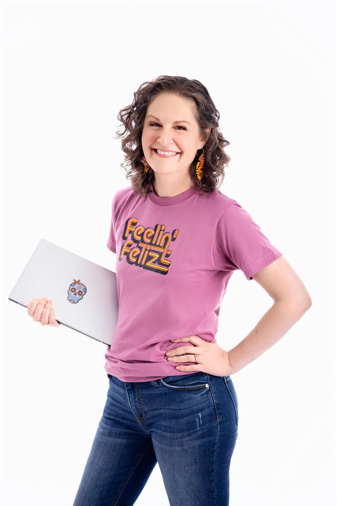 Chief Spanish Officer of Gringo Language Academy smiling and holding a laptop, standing confidently to greet visitors.