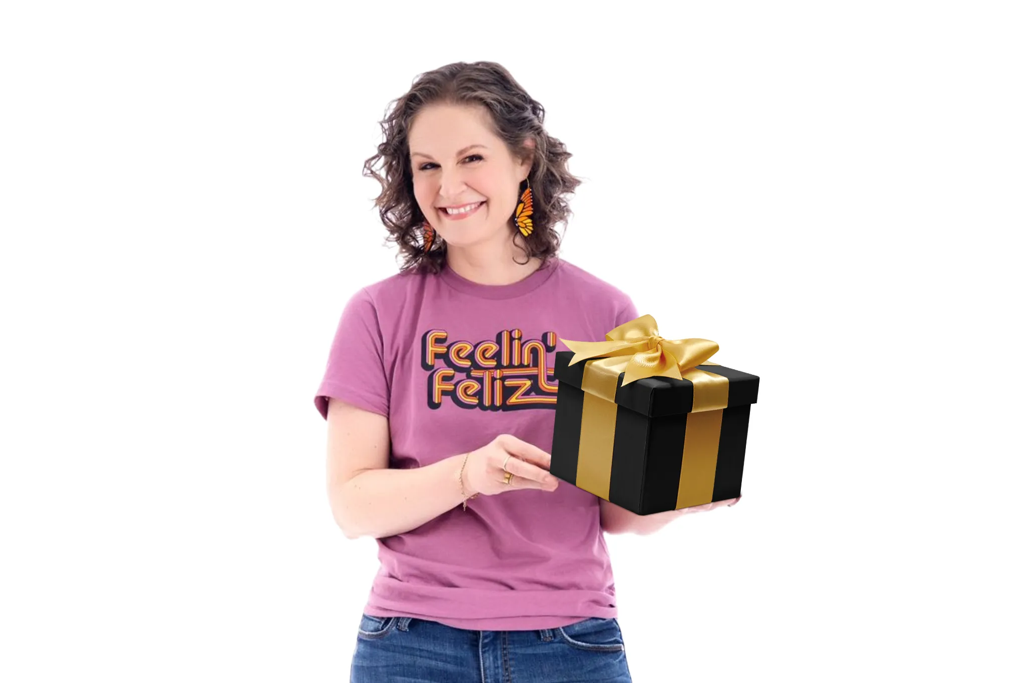 The Chief Spanish Officer, dressed in jeans and a bright T-shirt, holds a gift box and smiles, inviting others to share the Gift of Language.