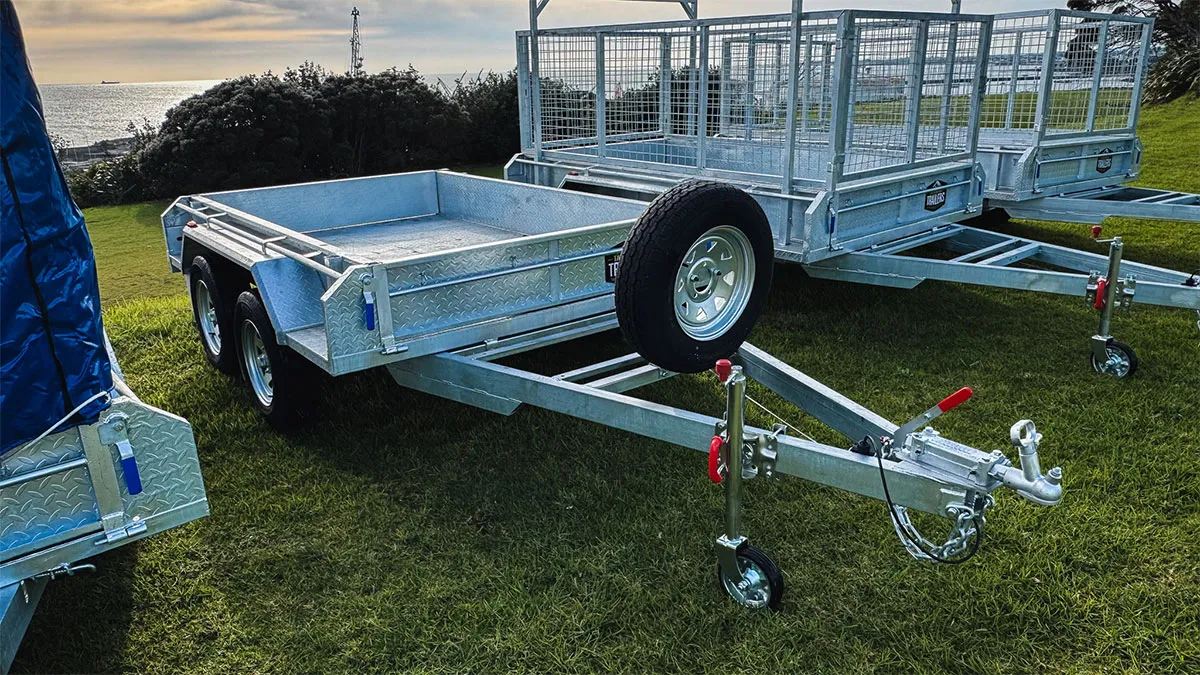 Metal flatbed utility trailer with dual axles.