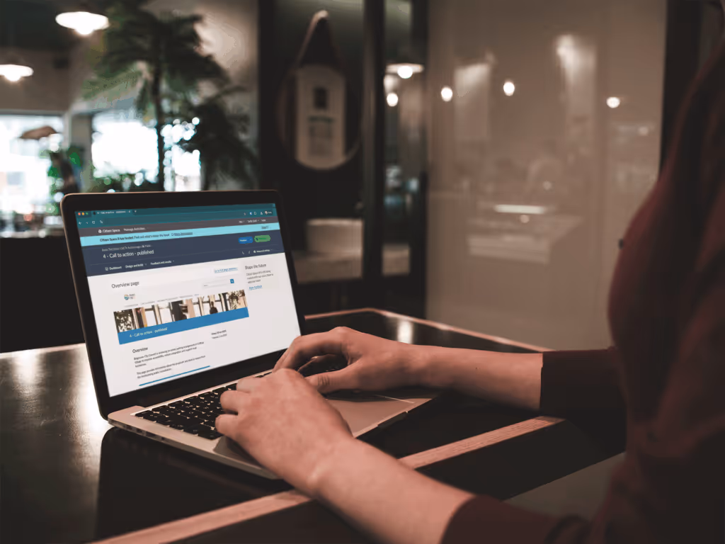 Woman working at a laptop looking at a govt site to submit a consultation response via Citizen Space