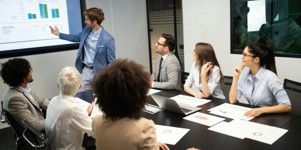 meeting room with a projector displaying graphs and data for a royal commission inquiry 