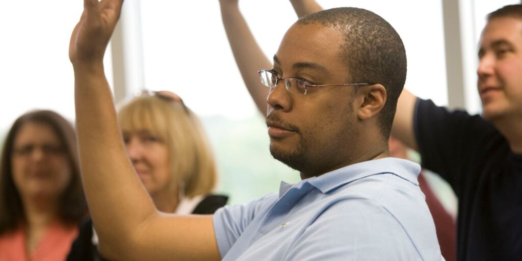 a panel of people raising their hands 