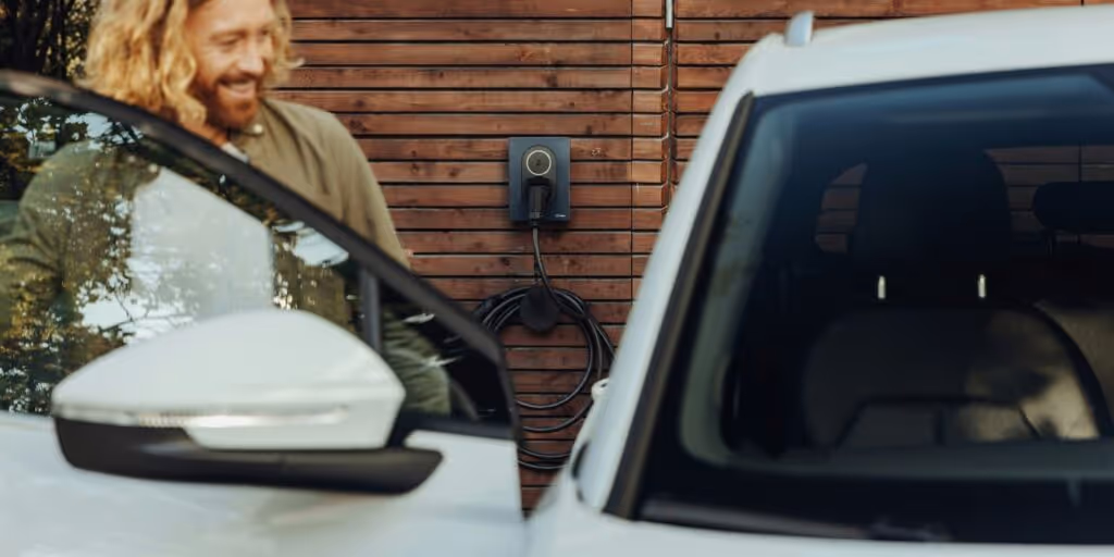 man opening a car to an electric vehicle