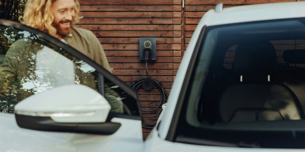 man opening a car to an electric vehicle