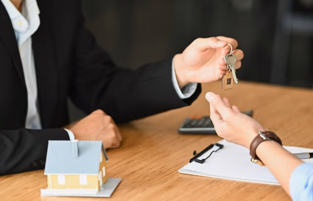 person handing resident keys