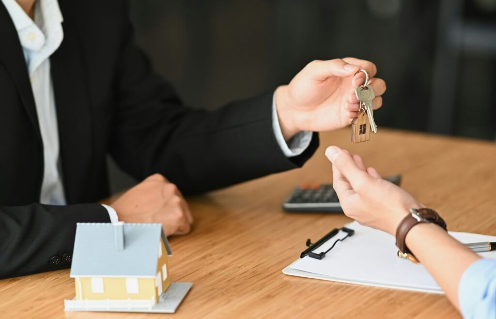 person handing resident keys