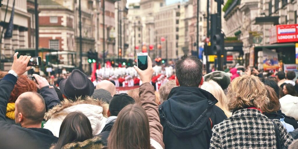 a crowd gathered on a busy london street